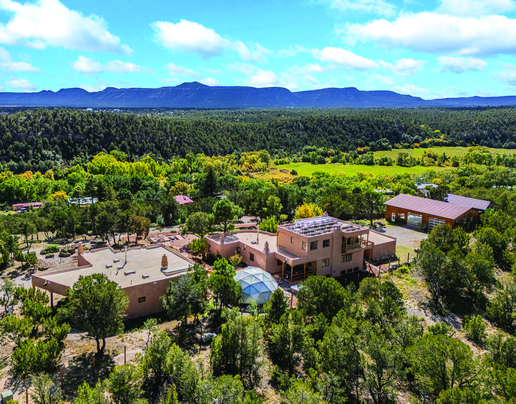 Traditional Santa Fe casita with adobe walls and portal, guest house feature