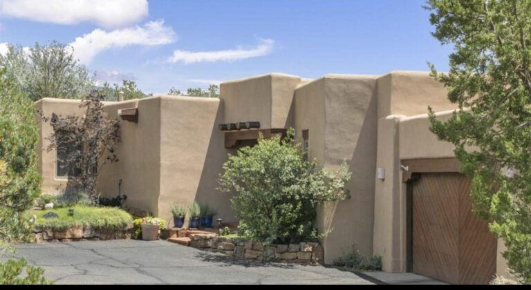 Adobe exterior with stepped parapets and planted courtyard at 1351 Barranca De Oro, Las Barrancas, Santa Fe
