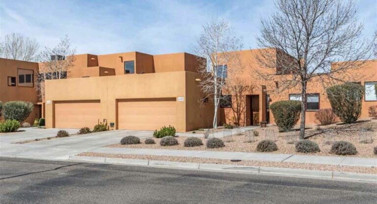 Street view of the Terraza unit with two car garage and xeriscaped frontage at 1440 Avenida Rincon, Zocalo, Santa Fe