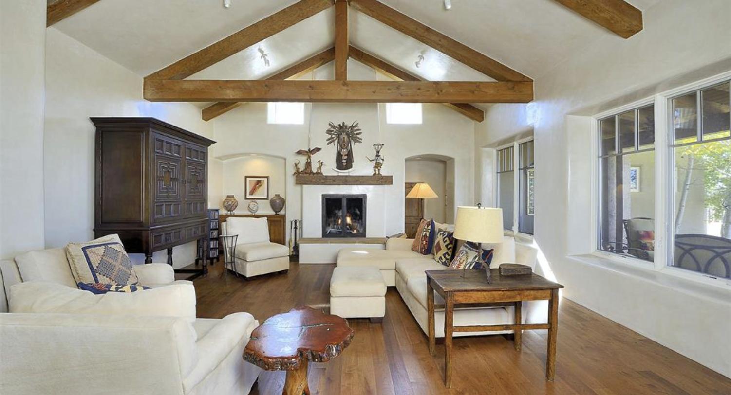 Great room with vaulted beamed ceiling, diamond plaster walls, and hardwood floors at 22 Lodge, Bishop's Lodge Hills, Santa Fe