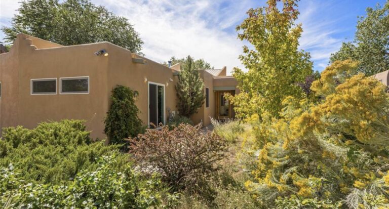 Adobe house set behind established gardens at 260 Camino Del Olmo, Santa Fe