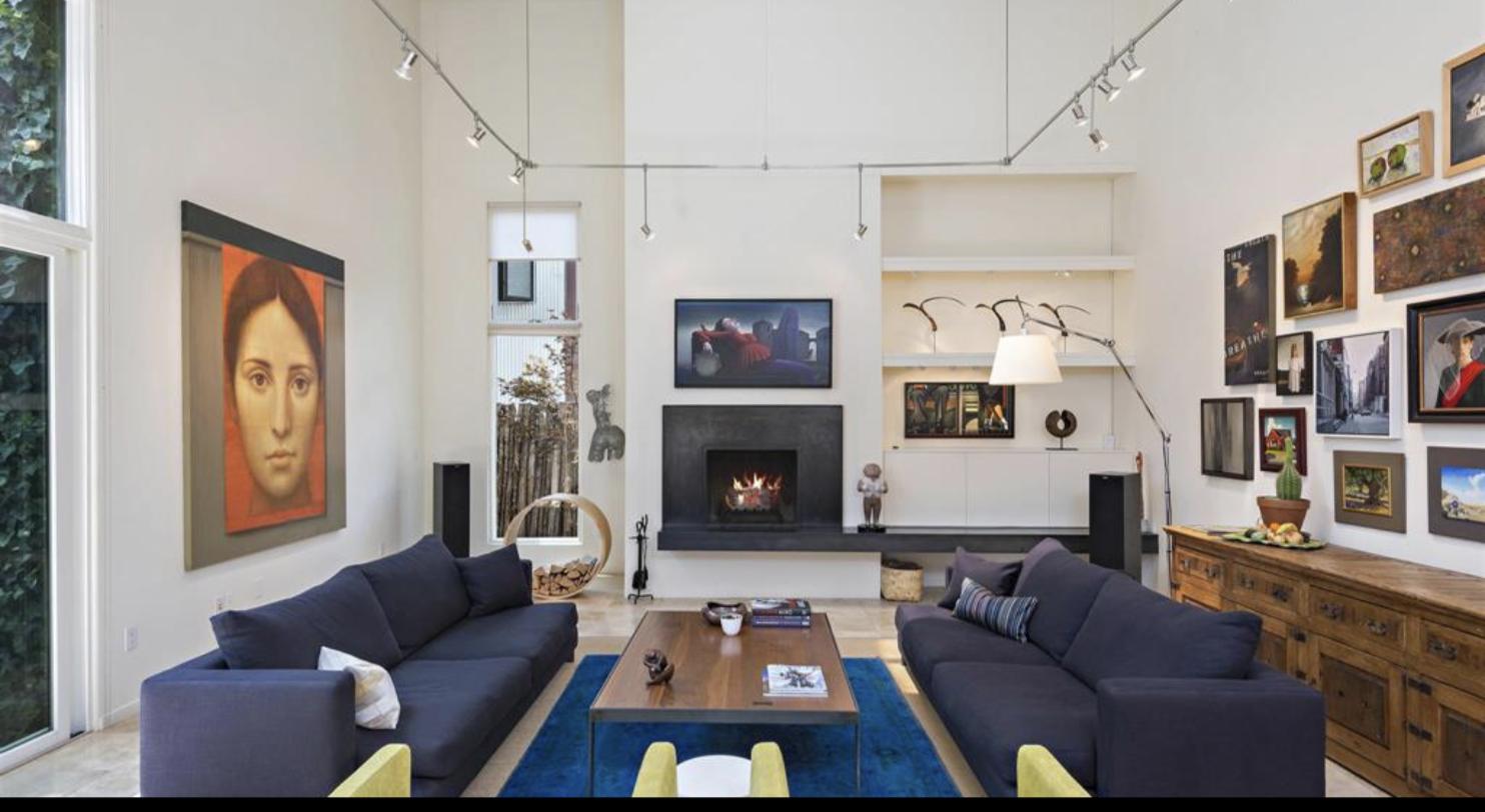 Double height contemporary living room hung with art at 473 Vista Joya, Santa Fe
