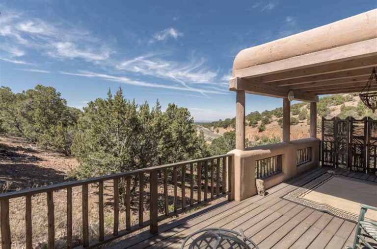 Covered portal and deck with piñon hillside views at 833 Canada Ancha, Santa Fe